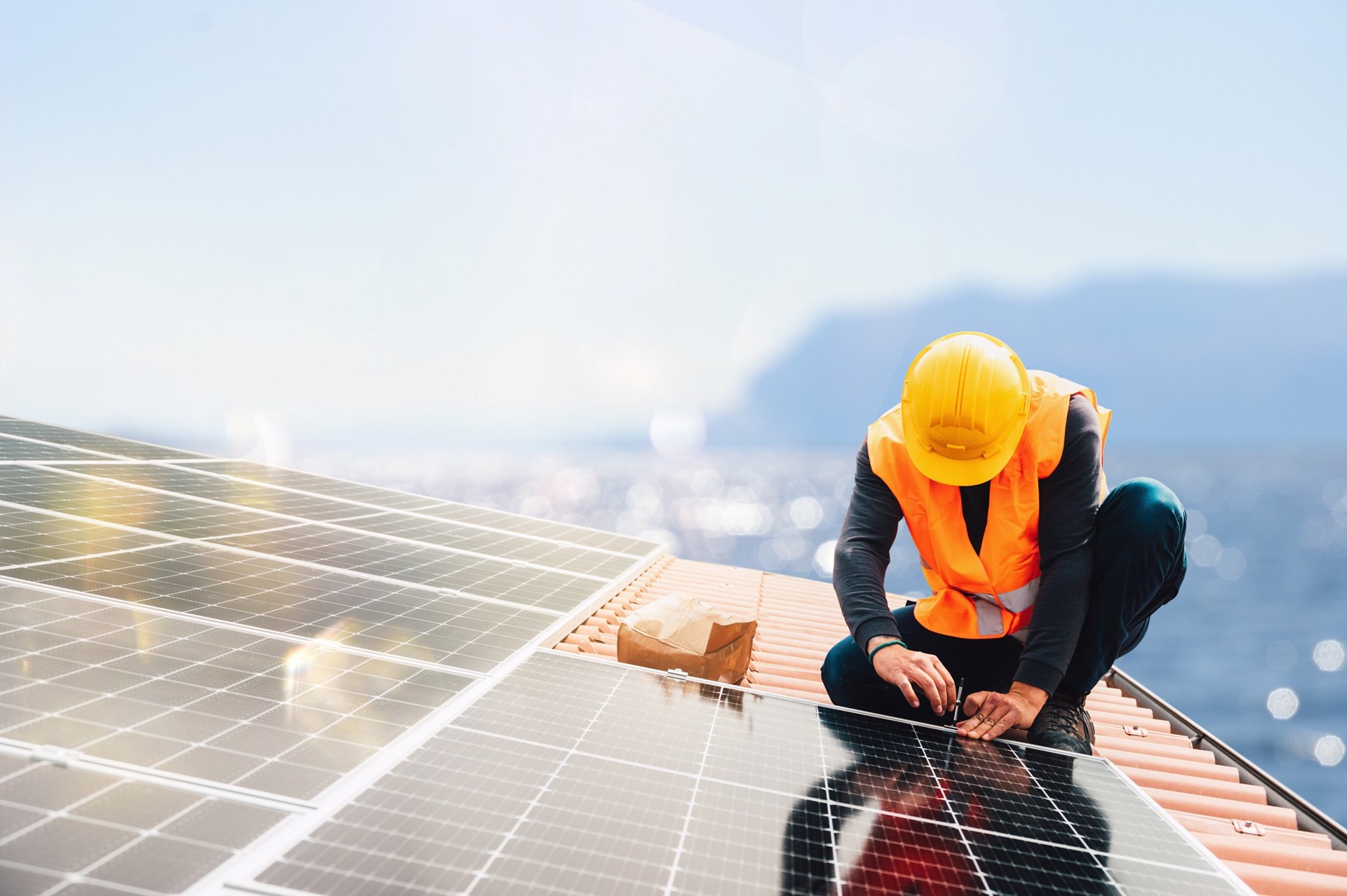 Expert solar installer installing array on commercial property.
